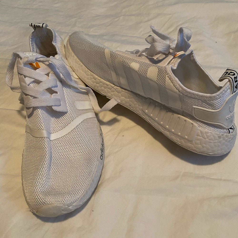 All white adidas running shoes